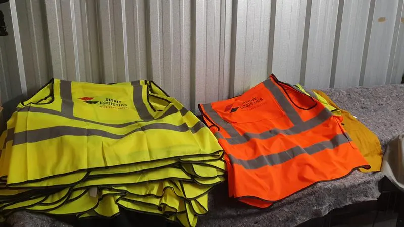 Hi-vis safety vests with custom embroidered logos for construction workwear in Manchester